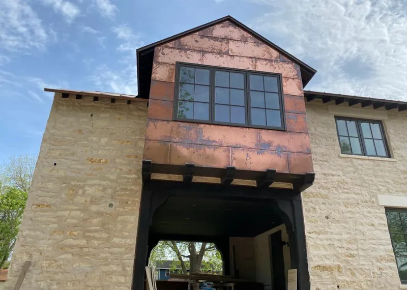 Copper metal panel facade on a stone building for Skylight Installation in Mount Hood Villages